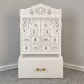 White Wooden Floor Pooja Mandir with Laser-Cut Lotus Om Design, Shubh Labh Motif, Bell Pattern Doors With Cabinet